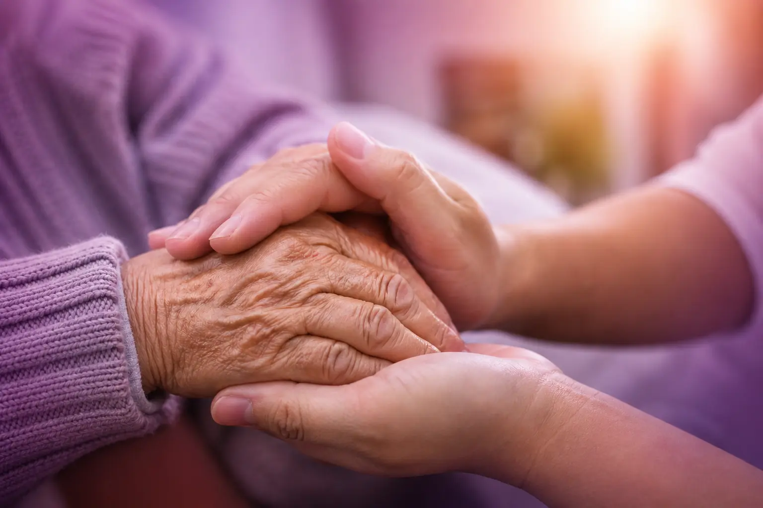 Guardian Nursing Agency support worker holding an older person’s hand with compassionate personalised care